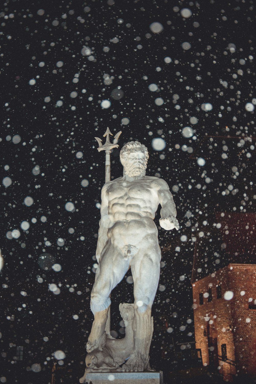 a statue of a man holding a cross in the snow