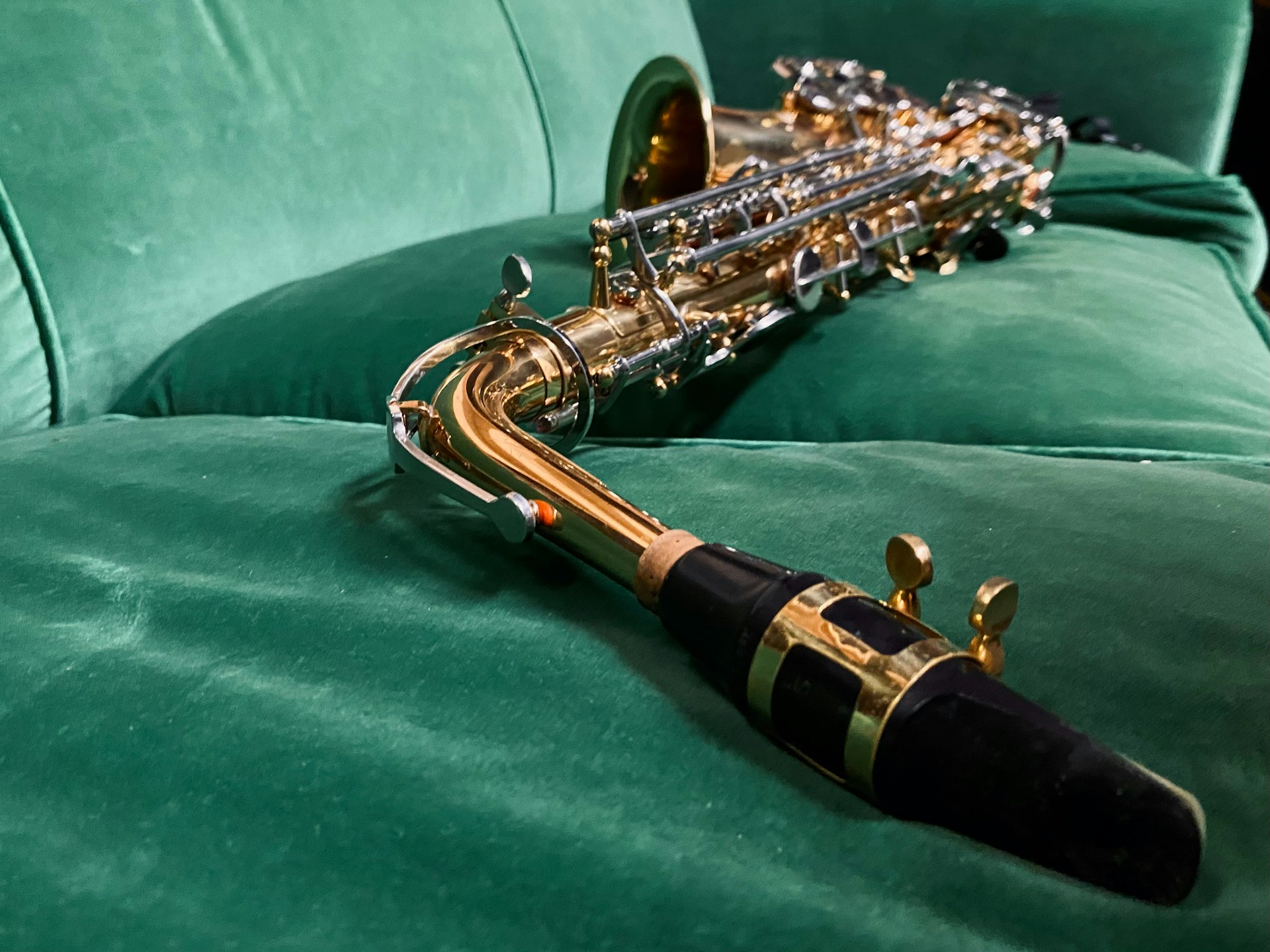 a close up of a saxophone on a green couch
