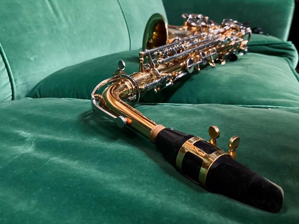 a close up of a saxophone on a green couch