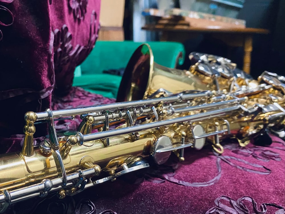 a close up of a saxophone on a bed
