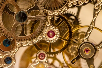 a close up of a clock with gears attached to it
