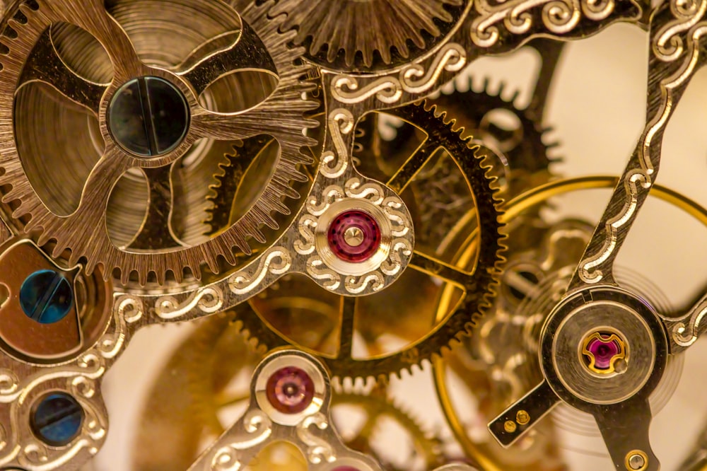 a close up of a clock with gears attached to it