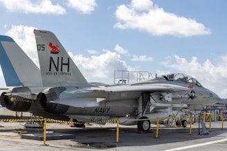 a fighter jet sitting on top of an airport tarmac