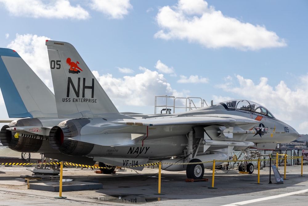 a fighter jet sitting on top of an airport tarmac