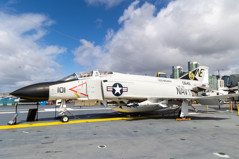 a fighter jet sitting on top of an airport tarmac