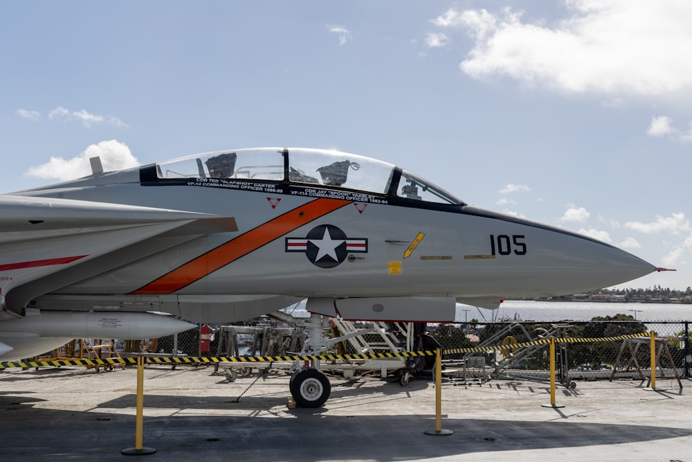 a fighter jet sitting on top of an airport tarmac