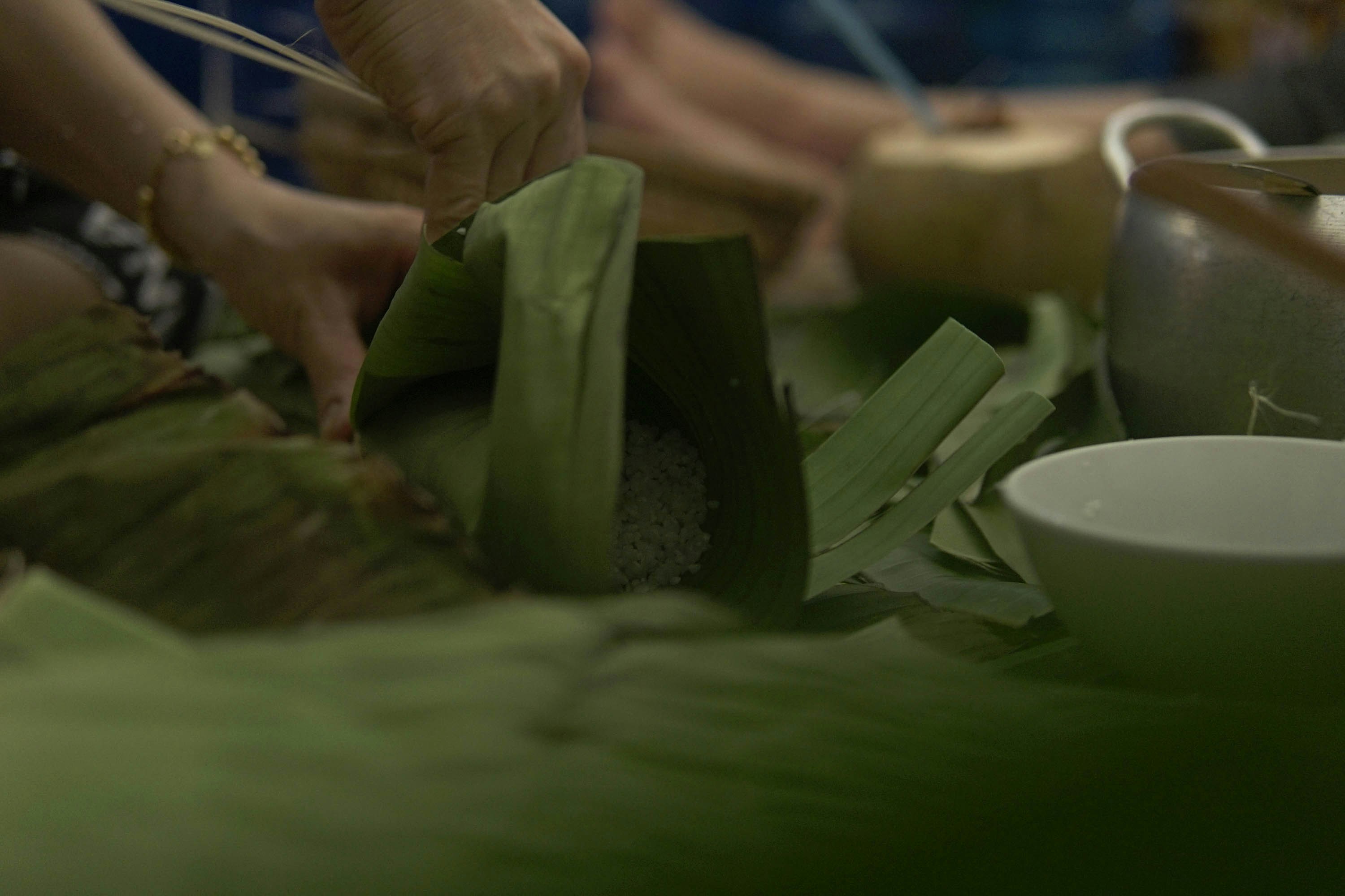 a group of people preparing food on a table
