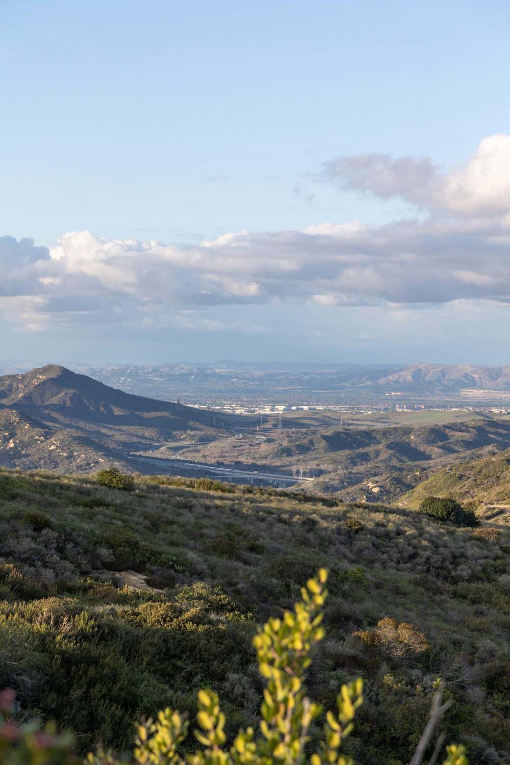 a view of a valley with mountains in the distance