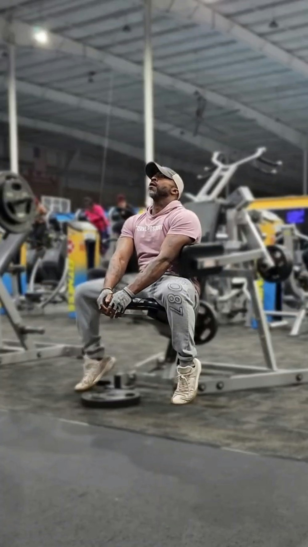 a man sitting on a bench in a gym