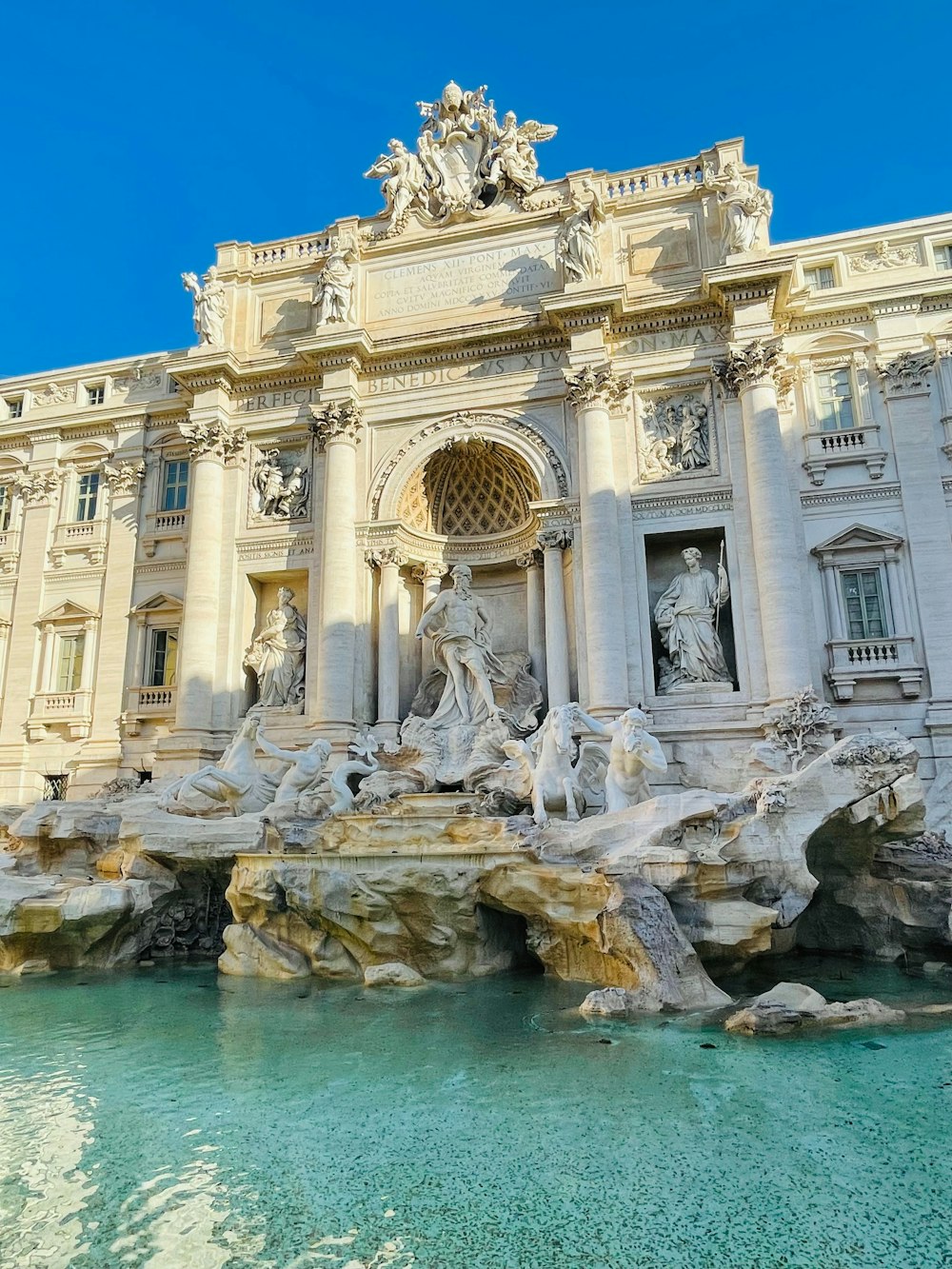 a large building with a fountain in front of it