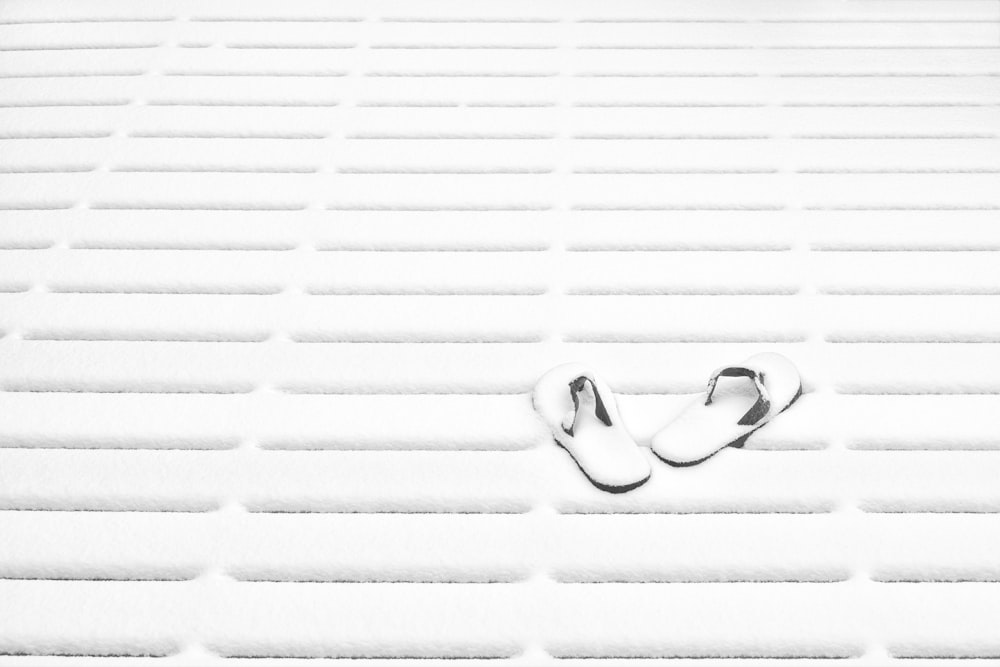 a pair of shoes sitting on top of a snow covered ground
