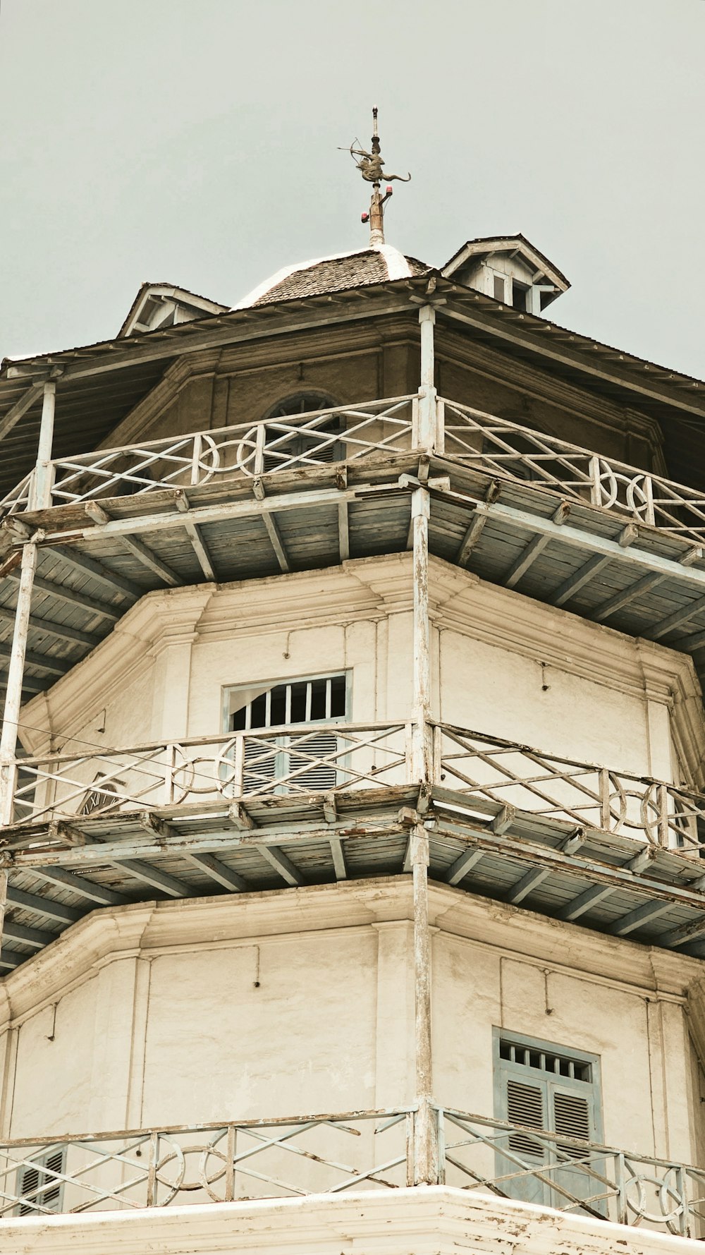 a tall tower with a cross on top of it