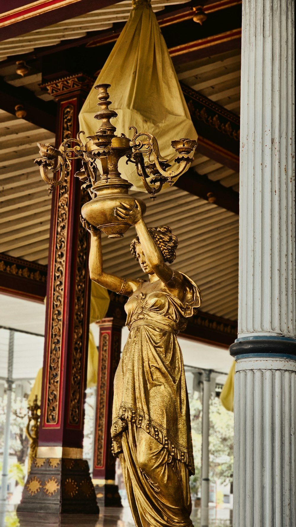 a statue of a woman holding a lamp