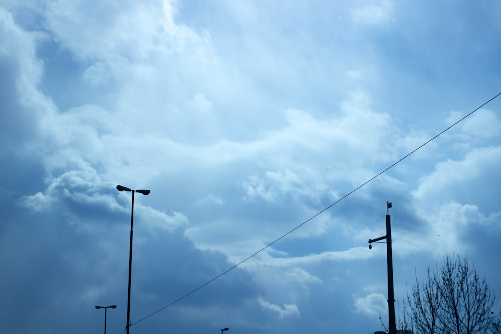 a street light and street lamps against a cloudy sky