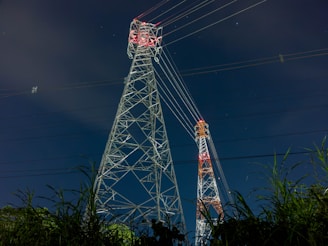 a tall tower sitting next to a lush green field