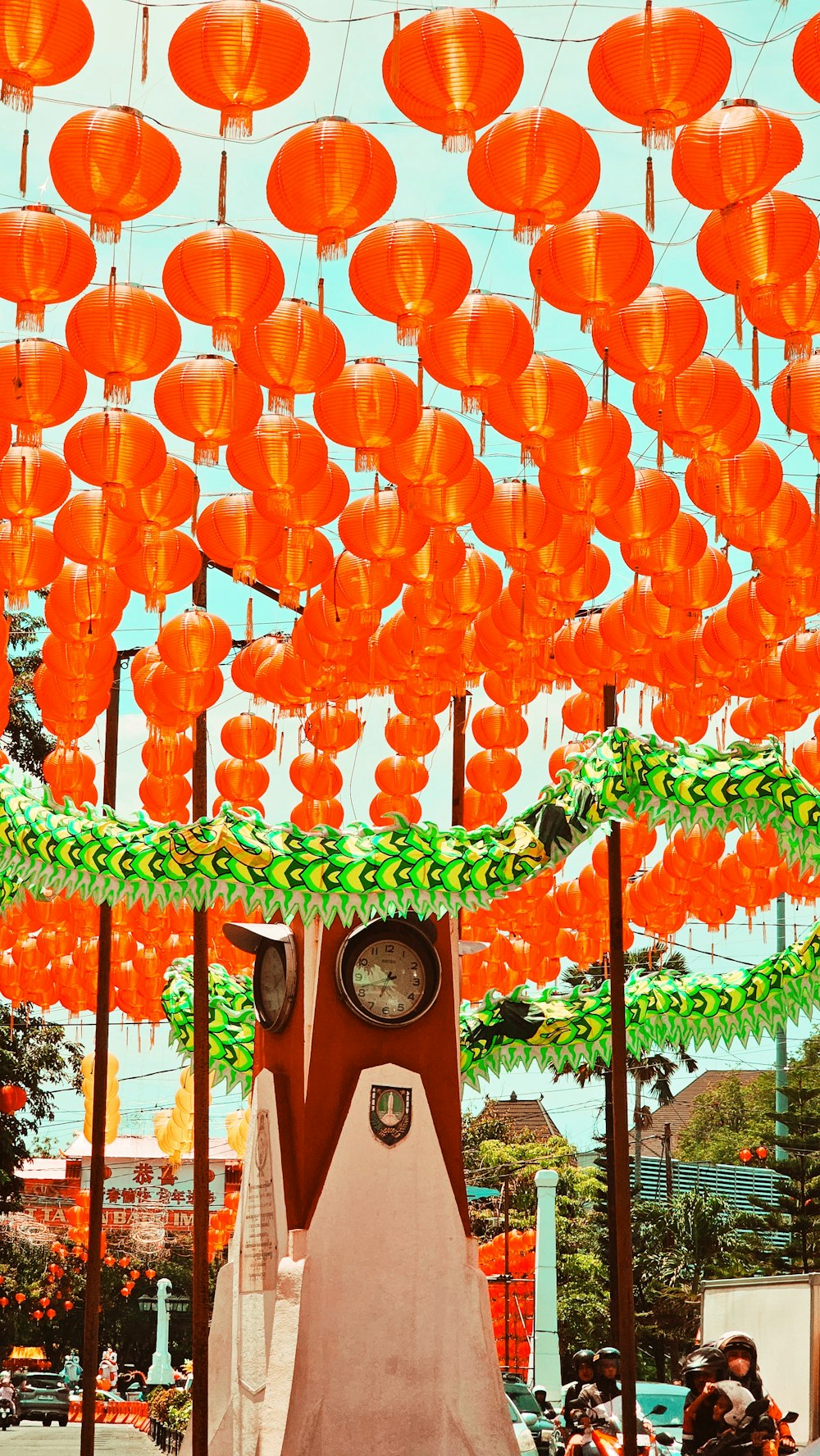 a group of orange lanterns hanging from the ceiling