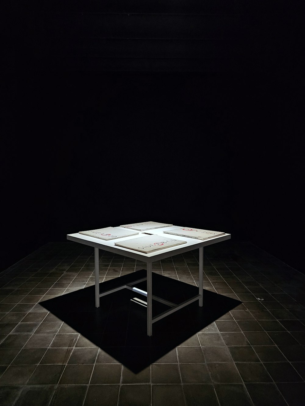 a white table sitting on top of a black floor