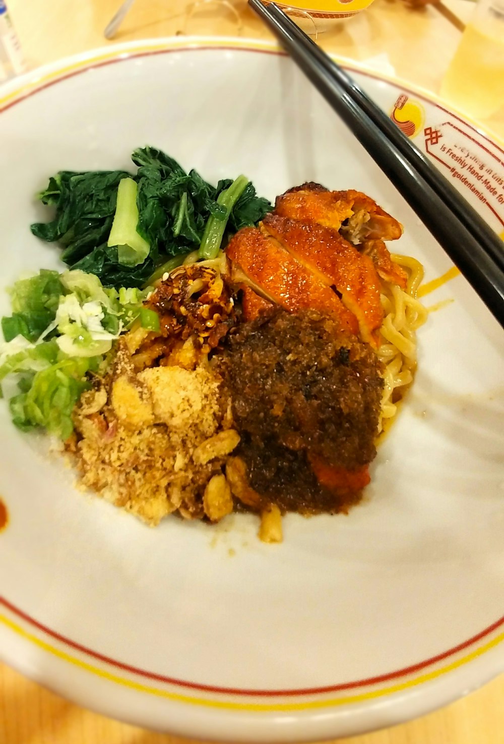 a plate of food with chopsticks on a table