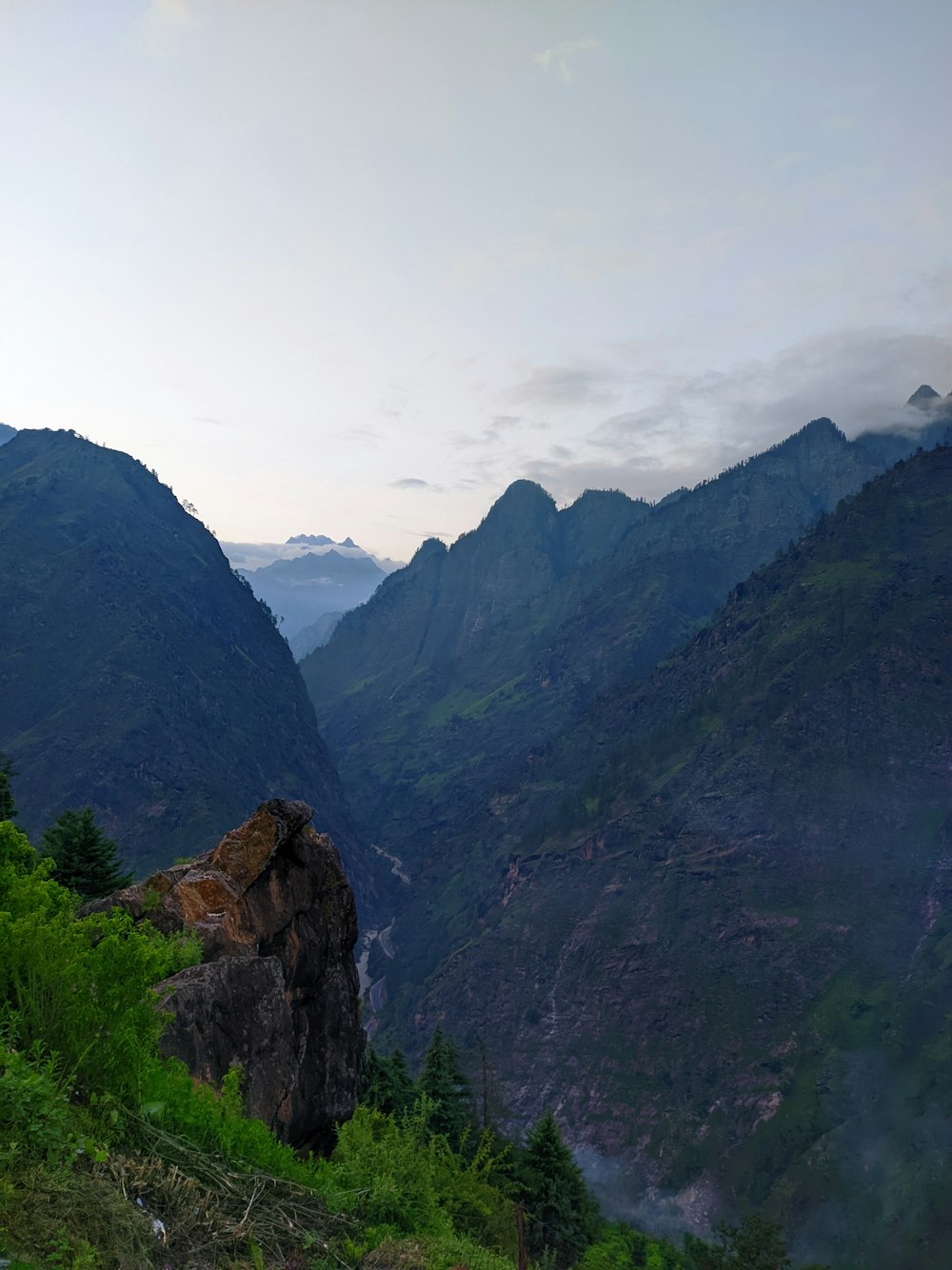 a view of a valley with mountains in the background