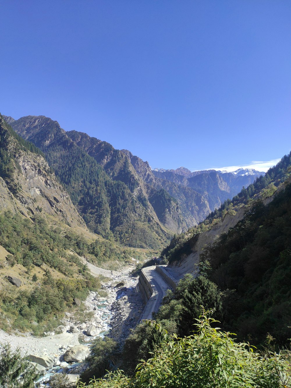 a river flowing through a valley surrounded by mountains