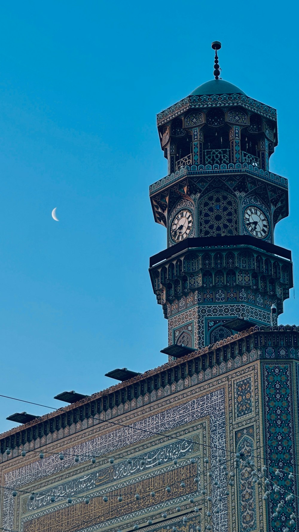 a tall clock tower with a clock on each of it's sides