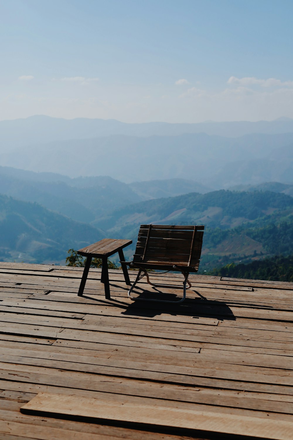 a wooden bench sitting on top of a wooden deck