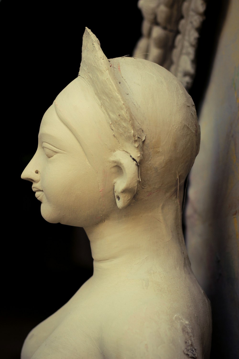 a white statue of a woman with a hairdow