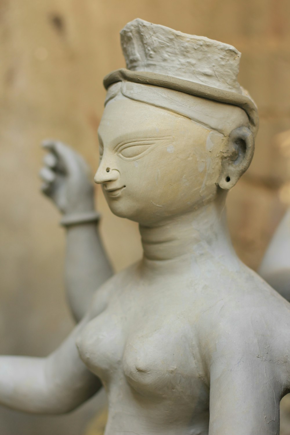 a statue of a woman with a hat on her head