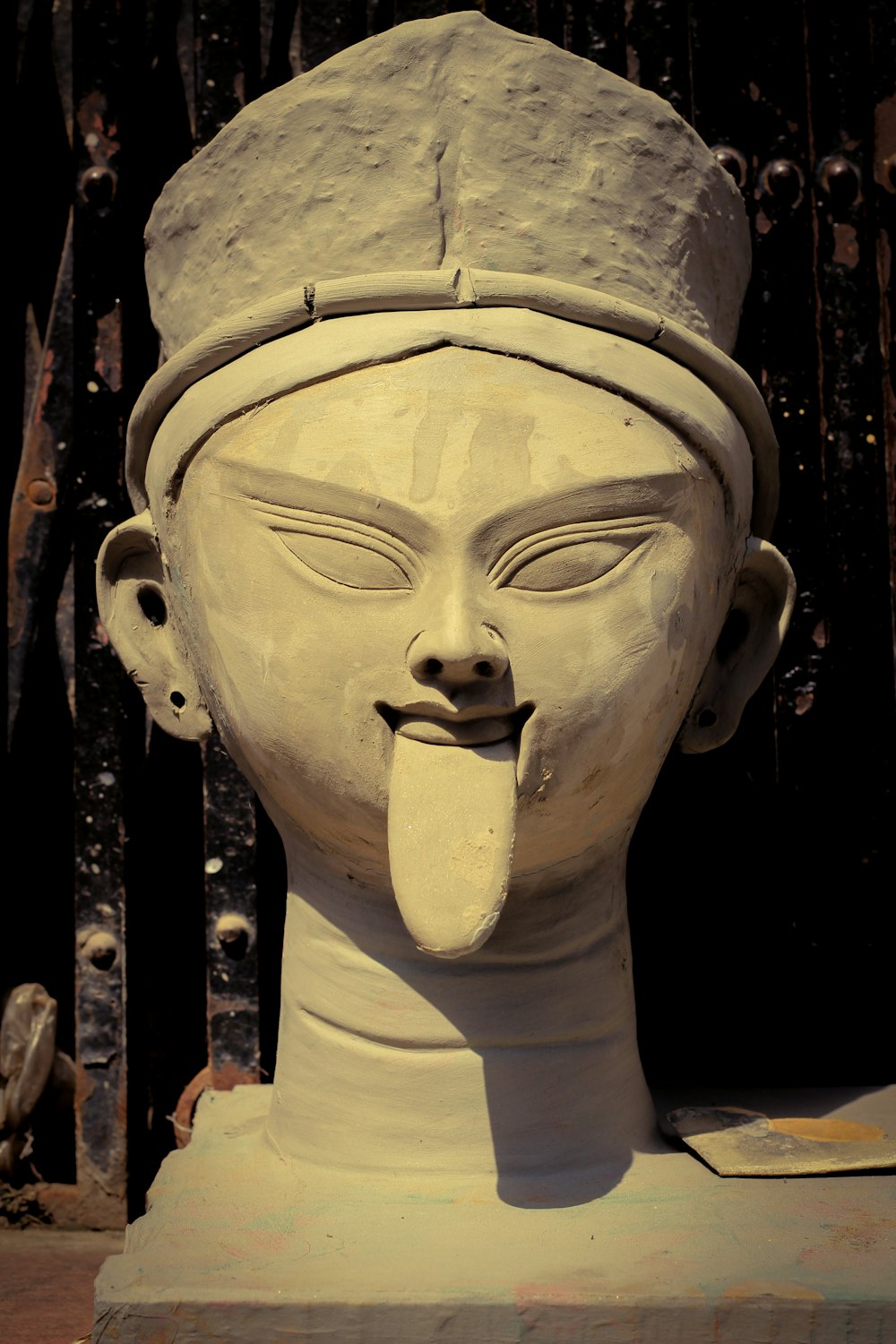 a statue of a woman sticking out her tongue