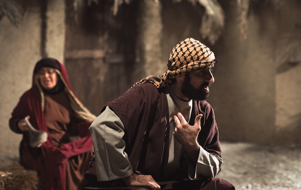 a man and a woman sitting on the ground