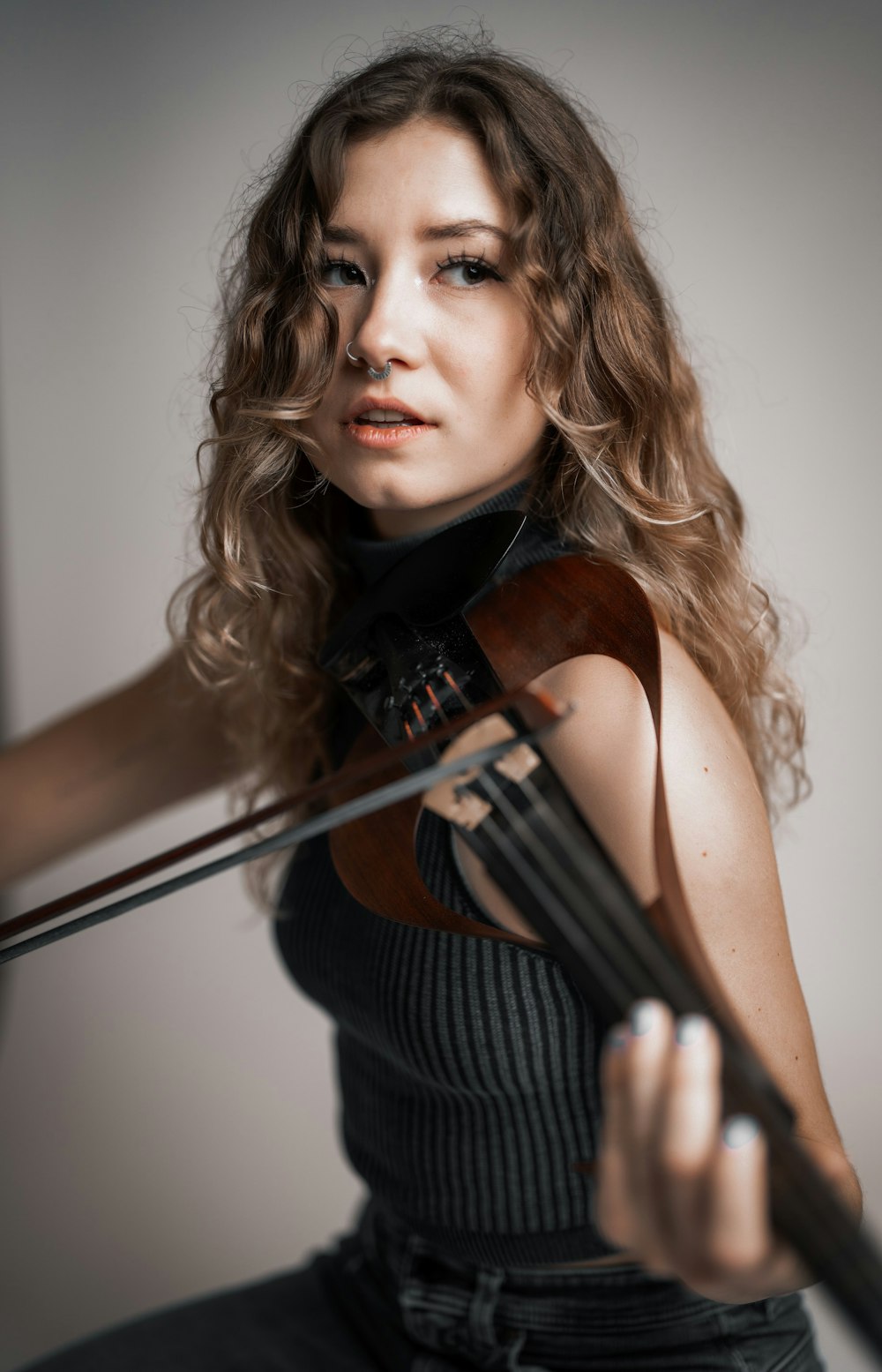 a woman holding a violin in her right hand