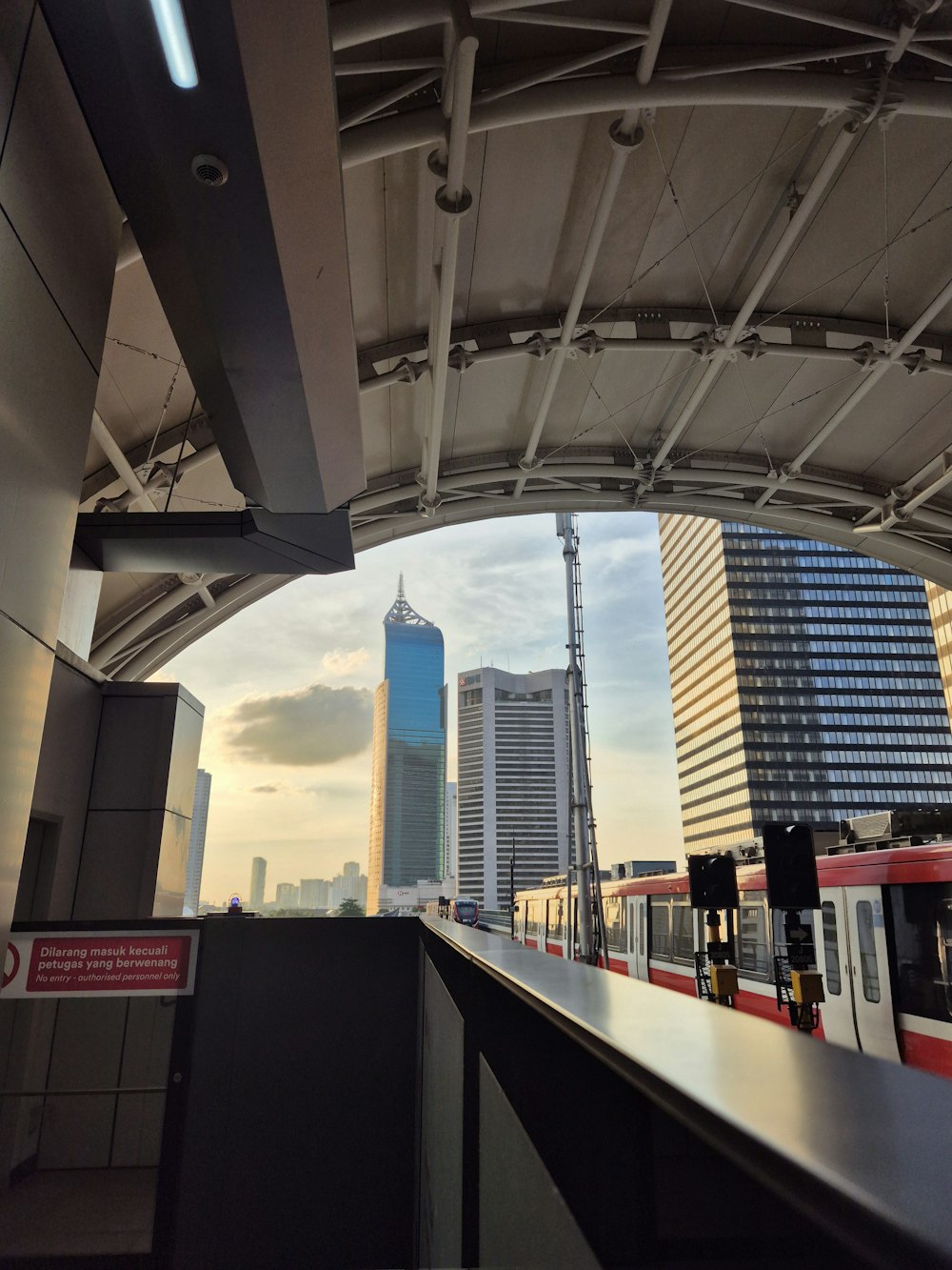 a train traveling through a train station next to tall buildings