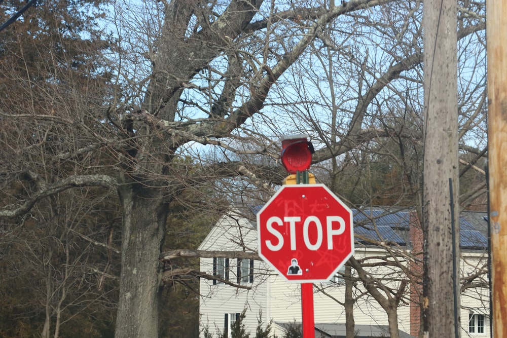 a red stop sign sitting on the side of a road