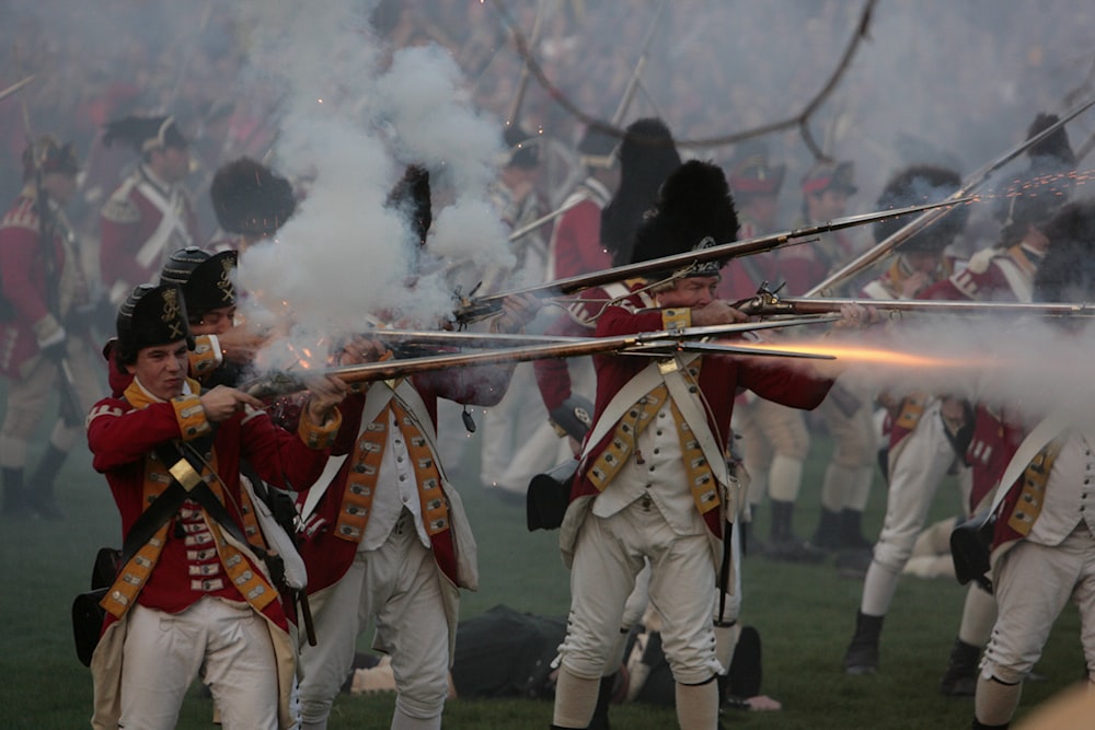 a group of men in uniform holding onto their guns