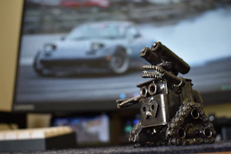 a metal sculpture of a car on a desk