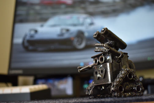 a metal sculpture of a car on a desk