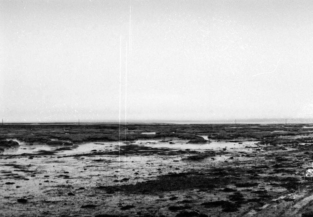 a black and white photo of a dirt field