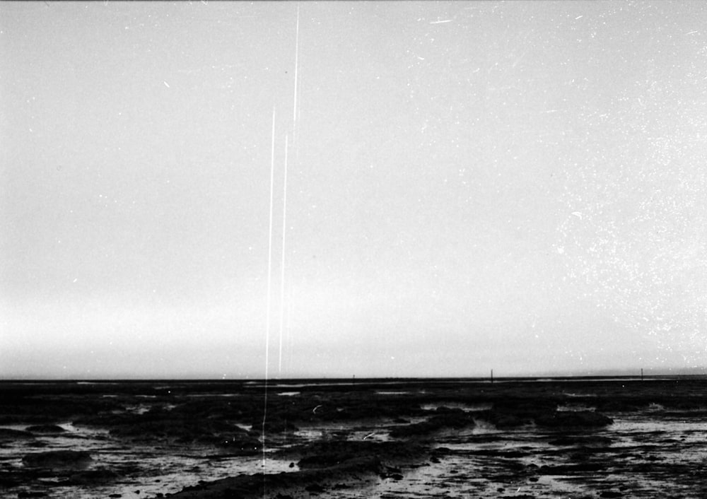 a black and white photo of a plane in the sky