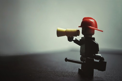 a lego man with a red hat and a yellow horn