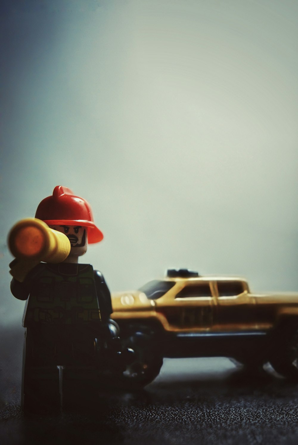 a toy fireman next to a toy truck