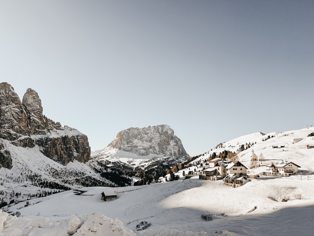 a snow covered mountain with a village in the distance