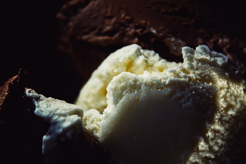 a scoop of ice cream sitting on top of a piece of chocolate