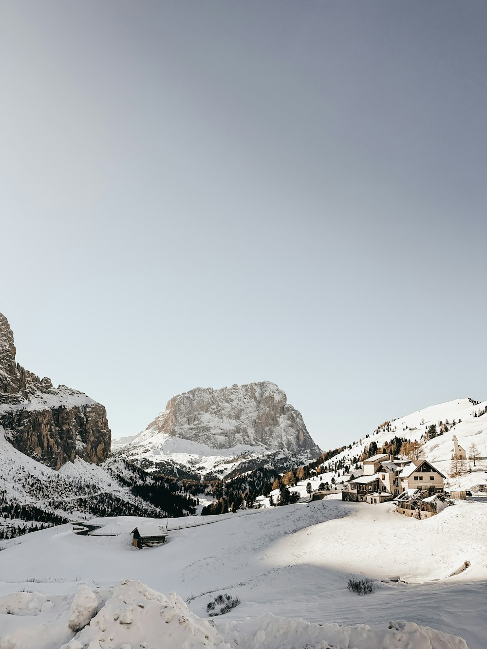 una montaña cubierta de nieve con un pueblo a lo lejos