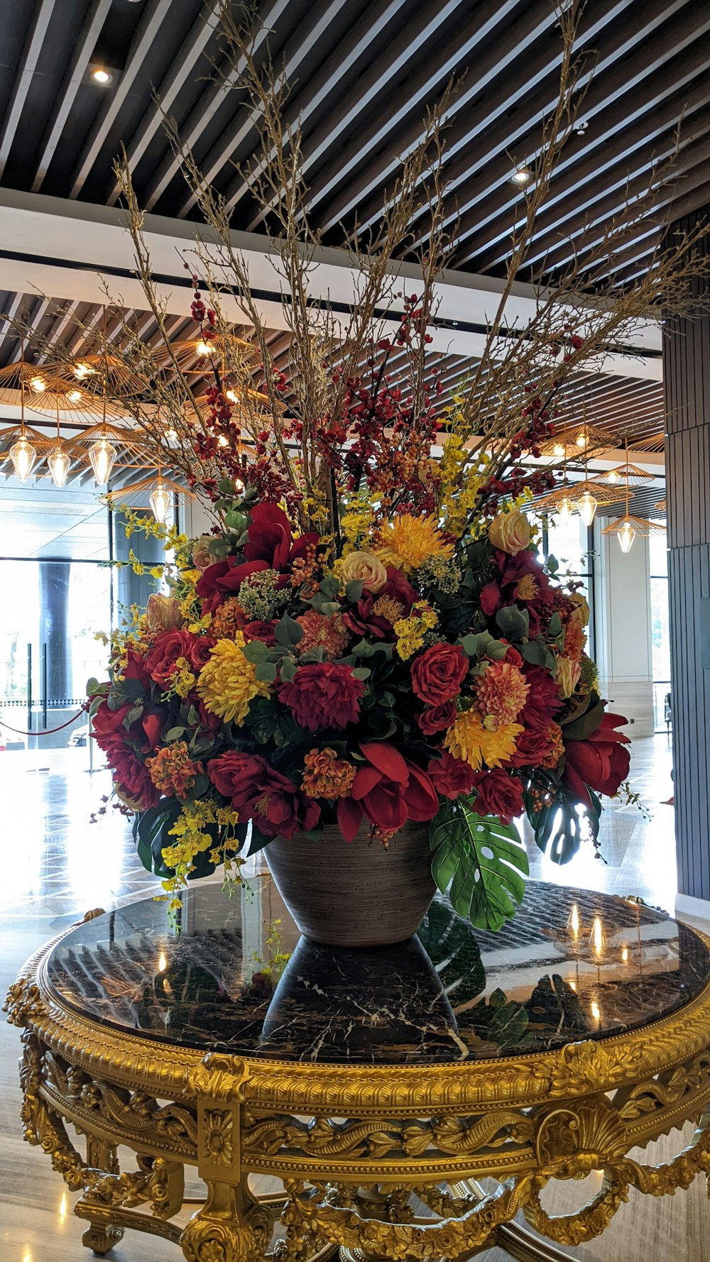 a vase filled with lots of flowers on top of a table