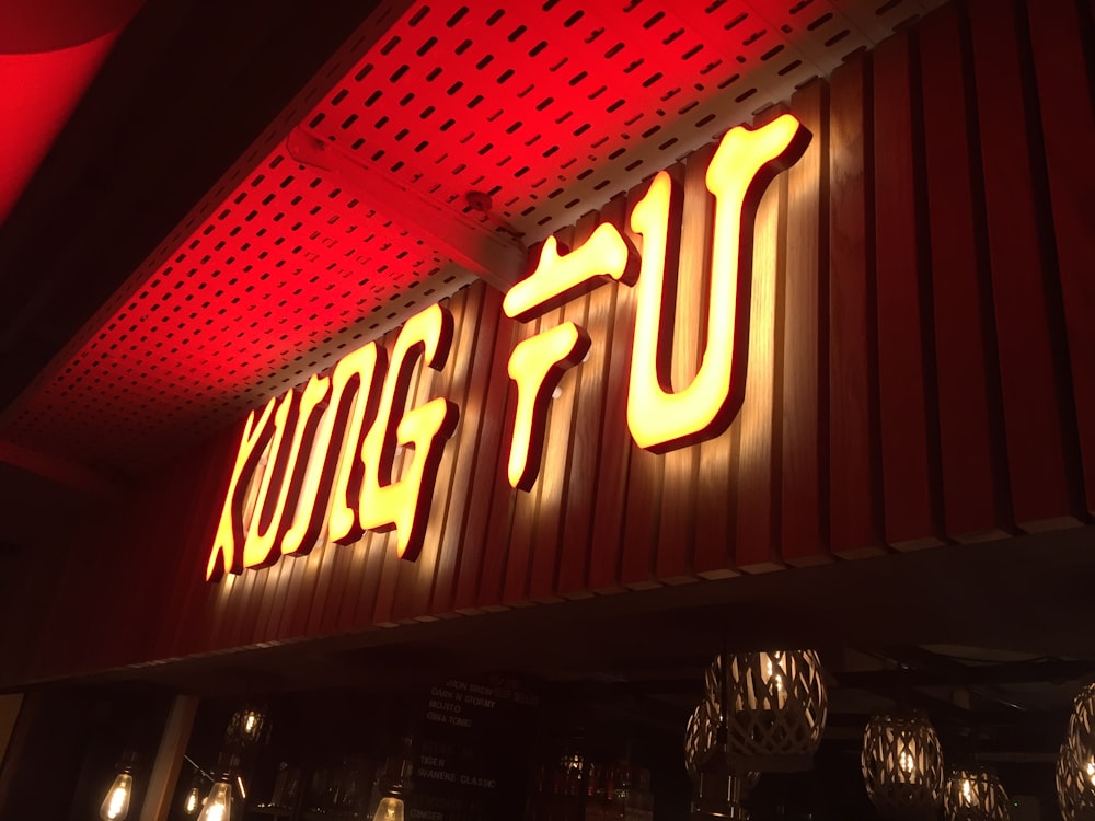 a restaurant sign lit up with red lights