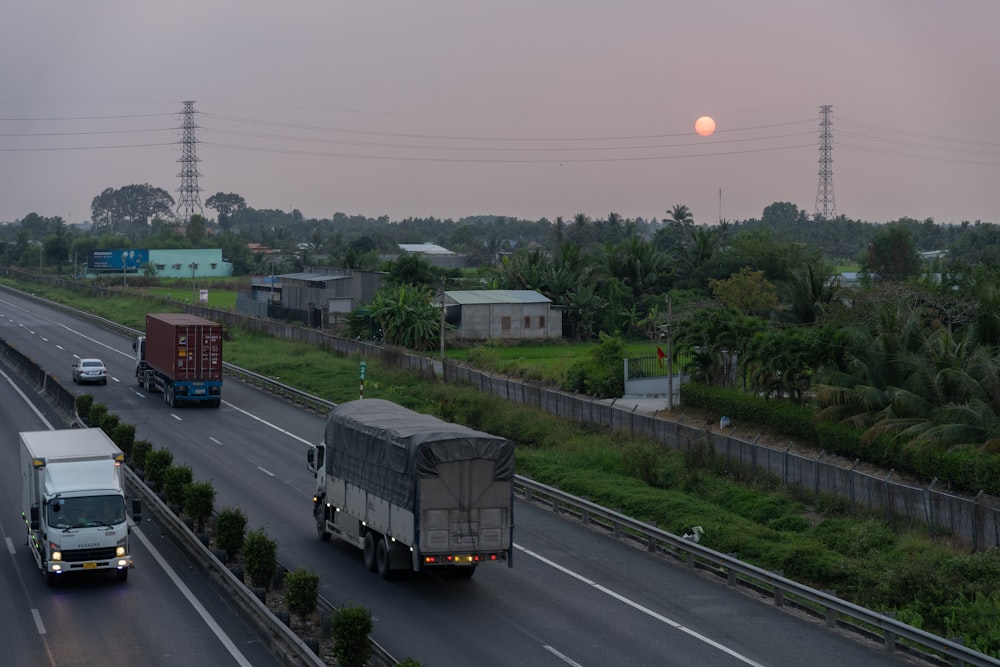 a couple of trucks driving down a highway