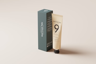 a tube of lotion sitting in front of a box