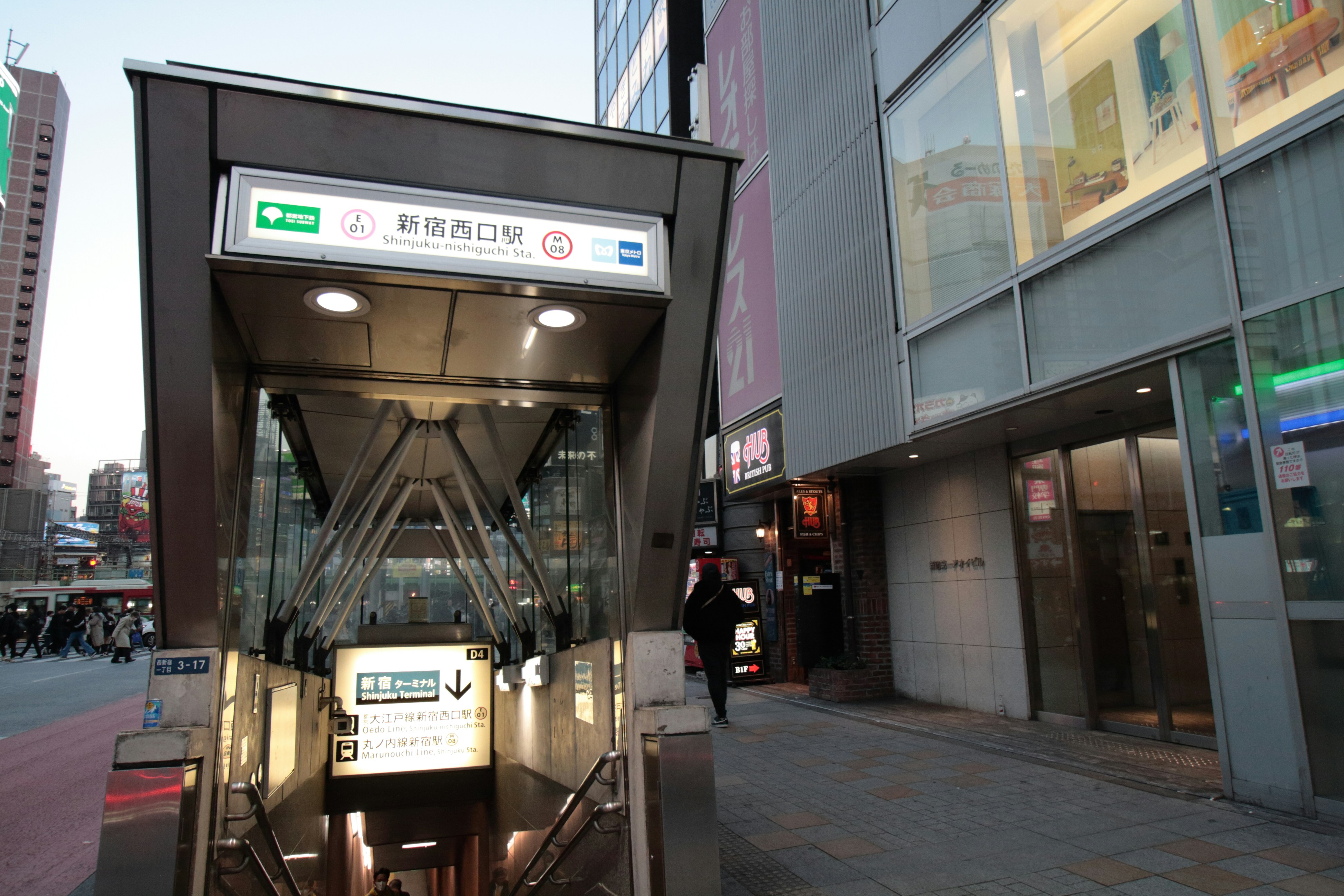 a bus stop on a city street next to tall buildings