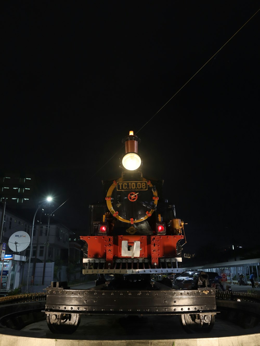 a train on a train track at night