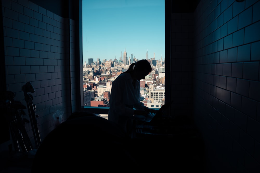 a man standing in front of a window in a room